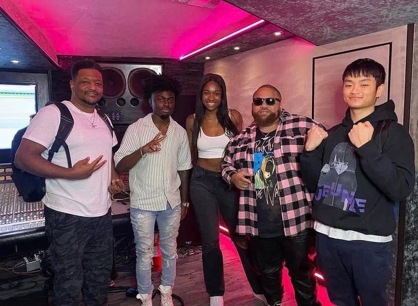 Keyz Bridgez with the crew in a pink-lit studio