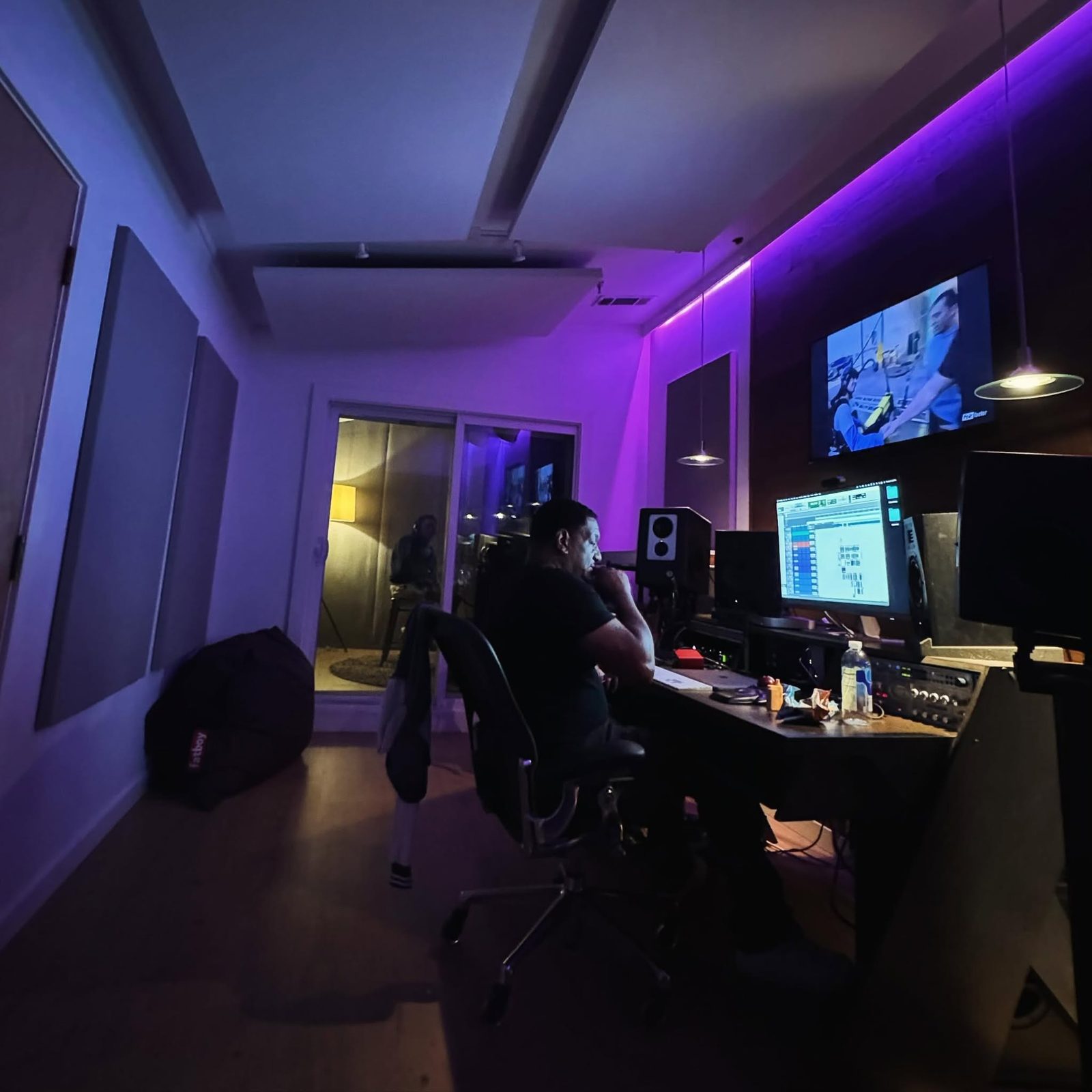 Keyz Bridgez at the desk in a purple-lit studio