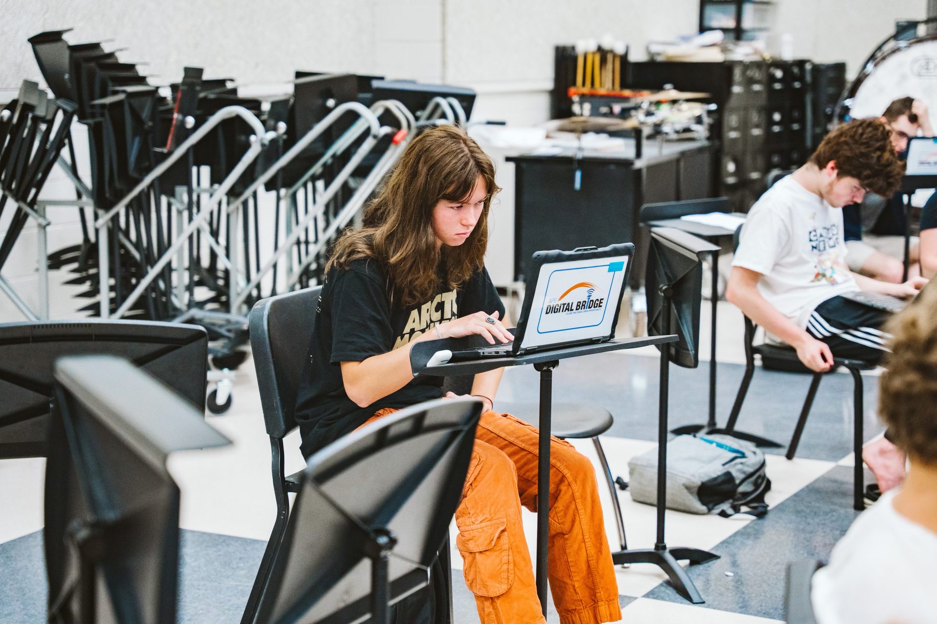 A student making music on her laptop